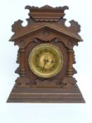 Late 19th century mantel clock in gingerbread style oak case with gold coloured Arabic dial,
