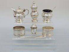 An Edward VIII three piece Harrods cruet set, Birmingham 1936, two napkin rings, a small pepper,