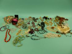 A collection of costume jewellery including beads, brooches,