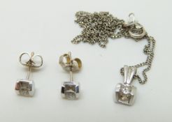 A 14ct white gold necklace and pendant set with a diamond and matching earrings