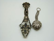 A silver-topped scent bottle with fleur de lys clip and a continental white metal vinaigrette
