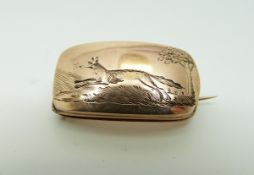 A Victorian rose gold brooch engraved with a fox in a landscape, 2.5 x 1.