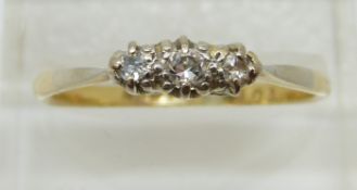An 18ct gold ring set with three diamonds in a platinum setting, 2.