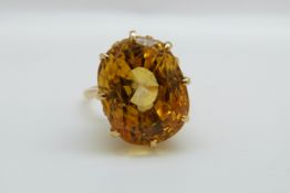 An 18ct gold ring set with a mixed cut natural untreated yellow sapphire measuring approximately
