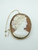 A 9ct gold brooch set with a shell cameo depicting a young women