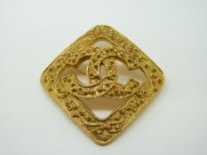 A Chanel gold tone brooch,