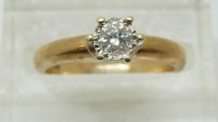An 9ct gold ring set with a round cut diamond of approximately 0.2ct, 2.