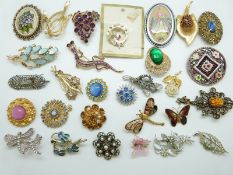 A collection of brooches including Hollywood