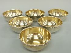 A set of six George V hallmarked silver finger bowls with gilt wash interiors and beaded rims,