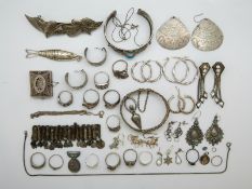 Eleven silver rings, five pairs of silver earrings, white metal fish pendant,