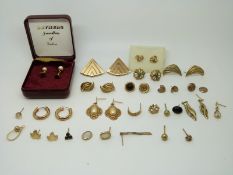 A collection of 9ct gold earrings including a pair set with pearl and a quantity of 9ct gold studs,