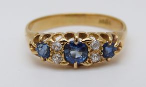 An 18ct gold ring set with three sapphires the largest approximately 0.