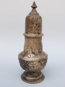 A large Victorian hallmarked silver repoussé sugar caster, London 1899 maker Carrington & Co.