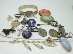 A silver buckle bangle by Excalibur, agate brooch, silver fob, silver St Christopher, silver badges,