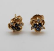 A pair of 18ct gold earrings set with sapphires and diamonds