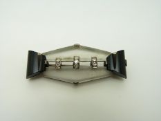 An Art Deco silver brooch set with seven diamonds with black onyx and clear sections, 4 x 1.