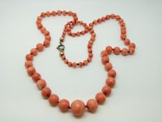 A graduated coral bead necklace with plated clasp