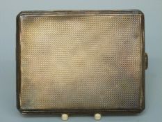 A hallmarked silver cigarette case with engine turned decoration, London 1932,