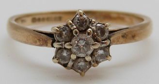 A 9ct gold ring set with diamonds in a cluster (size L)