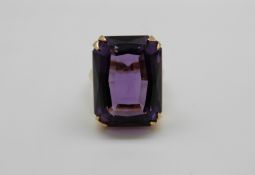 An 18ct gold ring set with a large emerald cut amethyst, 13.
