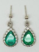 A pair of 18ct gold earrings set with a pear cut apple green emerald to each measuring approx 2ct,