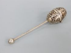 A Victorian hallmarked silver tea strainer or infuser with ball finial to the handle,