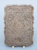 A Victorian hallmarked silver calling card case with hinged lid with engraved decoration,