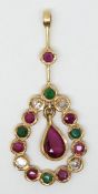 A yellow metal pendant set with a pear cut ruby surmounted by emeralds, diamonds and rubies.