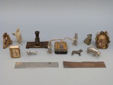 A small hand decorated icon pendant and miniature metal animals including a dachshund