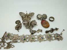 A collection of costume jewellery including filigree necklace set with enamel spiders in webs,