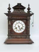 Junghans late 19thC mahogany cased mantel clock with carved decoration,