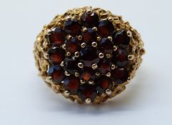 A 9ct gold ring set with a garnets in a cluster (size N)