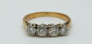 A yellow metal ring set with four diamonds totalling approximately 0.
