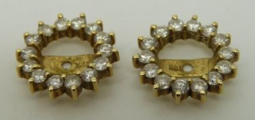 A pair of 14ct gold earring surrounds set with diamonds
