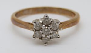 An 18ct gold ring set with diamonds in a cluster, total diamond weight approximately 0.25ct, 2.
