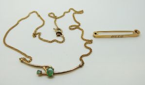 A silver gilt necklace set with oval emeralds and a 9ct gold brooch