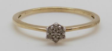A 9ct gold ring set with diamonds in a cluster, 1.