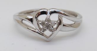 A 9ct white gold ring set with diamonds in a heart shaped setting, 1.
