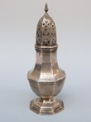 An Edward VII octagonal hallmarked silver sugar caster, Chester 1909 maker's mark rubbed, height 15.