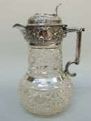 An Edward VII hallmarked silver mounted cut glass claret jug with pierced thumb piece,