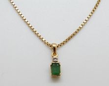 An 14ct gold pendant set with an emerald and a diamond on 14ct gold chain, 5.