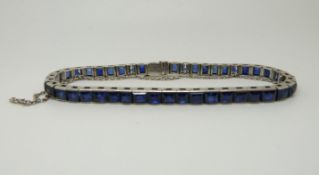 A Dreicer & Co white metal tennis bracelet set with 45 sapphires in square/rectangular step cut,