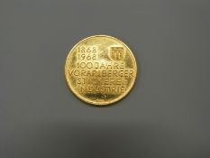 An Austrian gold coin commemorating 100 years of industry in Vorarlberg,