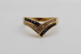 An 18ct gold ring set with square sapphires and diamonds in a V shape (size P)