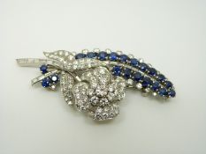 A platinum brooch set with 19 round cut sapphires,