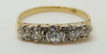 An 18ct gold ring set with five graduated diamonds, centre diamond approximately 0.