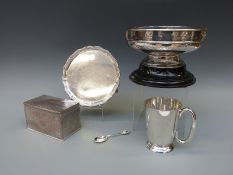 A plated hammered pedestal rose bowl with ornate decorative cartouches in relief on an ebonised