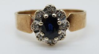 A 9ct gold ring set with a sapphire surrounded by diamonds (size M)