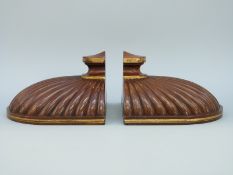 A pair of Regency mahogany pier / wall brackets of moulded shell form with gilded decoration,