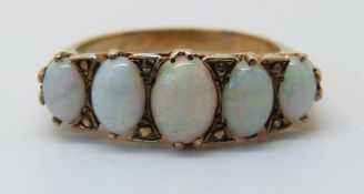 A 9ct gold ring set with five graduated opals (size O)